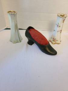 lot 1063 image: A pair of vintage ceramic hat pin holders and a metal pincushion shoe.