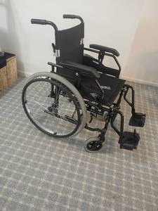 lot 2024 image: Karman Brand Wheelchair. Has a back pocket .   Located in basement