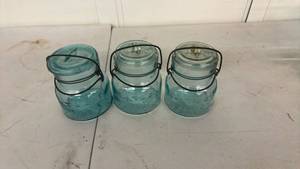 lot 38 image: 3 Teal Glass Canning Jars with Wire Bail Handles and Glass Lids