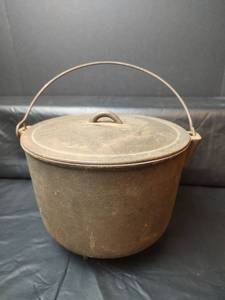 lot 215 image: Cast Iron No. 8 Three-Legged Dutch Oven with Lid and Bail Handle