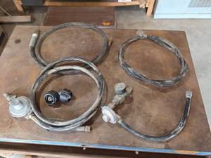 lot 1124 image: Assorted Propane Hose and Regulator Assemblies