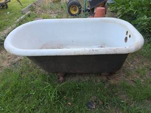 lot 1200 image: Clawfoot Bathtub with Claw Feet White- all feet are on it, needs good cleaning