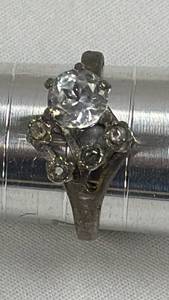 lot 34 image: Ring with faceted center stone and decorative setting