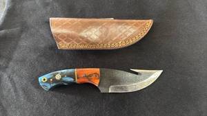 lot 2 image: Fixed Blade Knife with Blue and Orange Handle and Leather Sheath