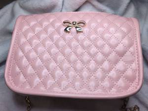 lot 2505 image: Pink Quilted Crossbody Bag with Bow Charm and Chain Strap
