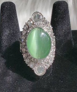 lot 3152 image: Green Oval Cabochon Ring with Rhinestone Halo Setting-Flexible Band