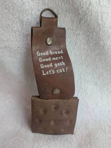 lot 1708 image: Leather Dinner Bell with Text Good Bread Good Meat Good Gosh Lets Eat