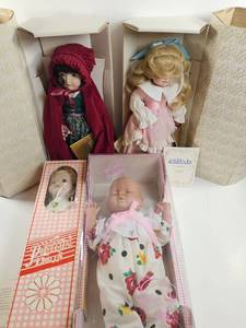lot 222 image: Lot of 4 Dolls in Original Boxes Porcelain Bisque Baby Crying Goldilocks