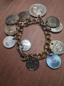 lot 1206 image: Multi-Coin Charm Bracelet with Foreign and British Currency Coins