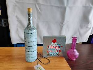 lot 1510 image: Decorative Bottle LED Light with Cork Stopper, Cherry on Top Sign, and Pink Vase