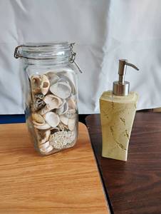 lot 1526 image: Pump Dispenser with Stone-Texture Body and Seashell-Filled Glass Clamp-Lid Jar 2-Piece Lot