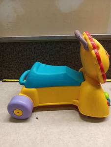 lot 32 image: Fisher-Price Lion Learning Toy with Wheels and Blue Carrier
