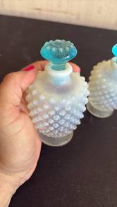 lot 2044 image: Pair Vintage Fenton Hobnail Clear and Opaque White Perfume Bottles w Blue Stoppers