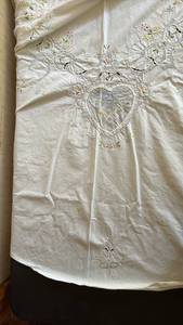 lot 2049 image: Round Embroidered Tablecloth with Floral and Figurative Details and Coordinating Napkins