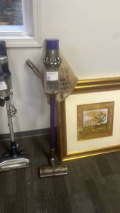lot 10093 image: Cordless Stick Vacuum Cleaner with Purple Handle and Dust Cup - Retail $0