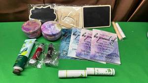 lot 504 image: Bundle with 4 Small Notebooks, 2 Candles, 3 Chalkboards with 2 different Chalk Colors, 2 Key Chain Lights 2 Chapsticks, and Green Tea Lotion. - Retail $15