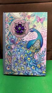 lot 586 image: Hard Cover 6x9 inch Peacock Journal with Raised Gym Flower. 128 Lined Double Sided Pages - Retail $29