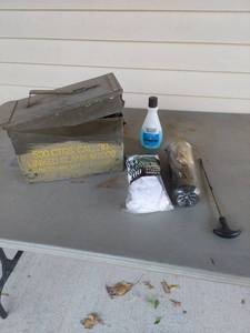 lot 1834 image: Metal Ammo Can with Partial Gun Cleaning Kit