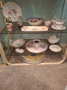 lot 1215 image: 2 Shelves of Decor - Porcelain Floral Decorated Plates Bowls Teapot Creamer