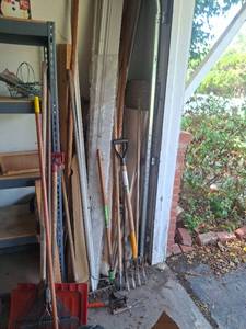 lot 1334 image: Long Handled Tools and Trim in Corner of Garage