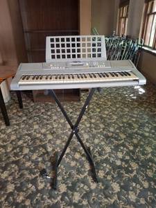 lot 1099 image: Yamaha electric keyboard with stand