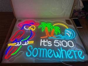 lot 9529 image: Its 500 Somewhere LED neon sign featuring a parrot and palm trees.