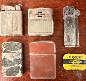 lot 525 image: Vintage Lighters and Flints in a Cigar Box