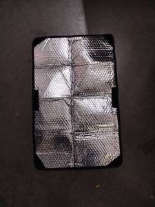 lot 2100 image: Small Sun reflector approximately 2 ft by 1 ft