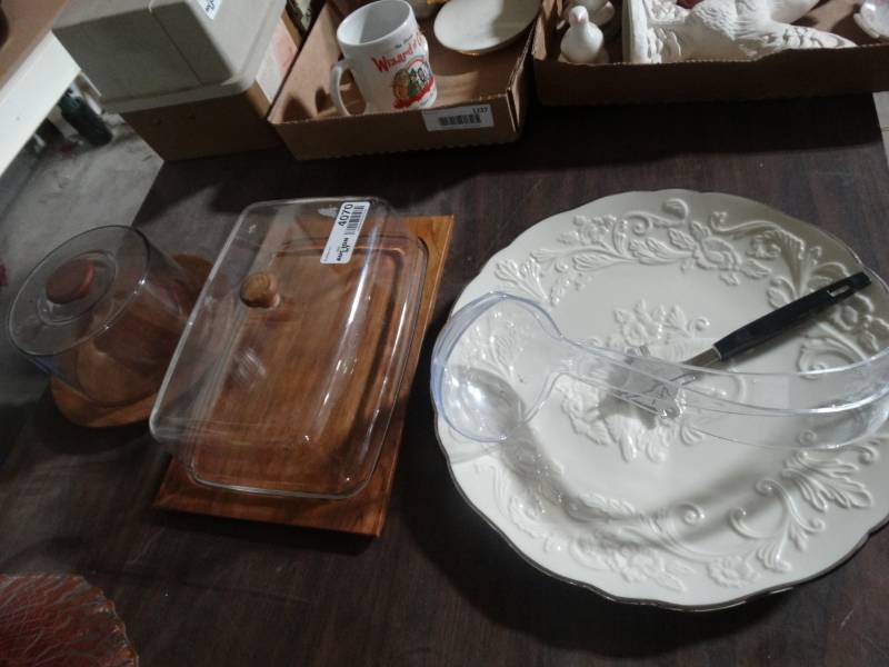 lot 4070 image: 2 Different size and shaped cake domes, glass platter, 2 plastic ladles and a grill scrapper.