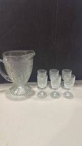 lot 1031 image: Jeannette Glass set in the Iris & Herringbone pattern pitcher and 6 cordial glasses