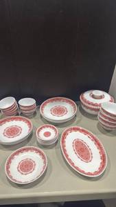 lot 1039 image: Red and White Ceramic Dinnerware Set with Bowls, Plates, and Covered Dishes, covered dish has chips on bowl and lid set of 27