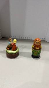 lot 1054 image: music box made in Japan, featuring ceramic figurines of a young boy and girl with a bird and Russian nesting doll