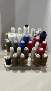 lot 1108 image: Sewing Thread Spool Rack with Approximately 33 serger thread cones Mixed Colors