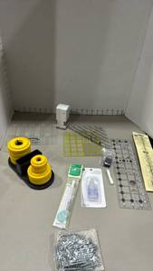 lot 1151 image: OLFA Rotary Cutter System Organizer featuring fabric and pattern weights, grids, tape measure and more