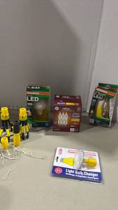 lot 2069 image: LED Light Bulbs and Accessories Lot Sylvania Ultra 100W, GE Relax 6-Pack, Sylvania 40W, Light Bulb Changer