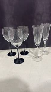 lot 1143 image: Three Vtg Luminarc Black Wine Glasses with Two Vtg Mikasa Champagne Flutes that both have very small chips on rim. Shown in photos