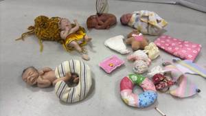 lot 1208 image: 3 to 4 inch Baby Doll Figures with Accessories and Clothing. Foot needs glued back on.
