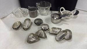 lot 1225 image: Measuring Cups, Citrus Juicer, Shell Molds and  Apple Cutter