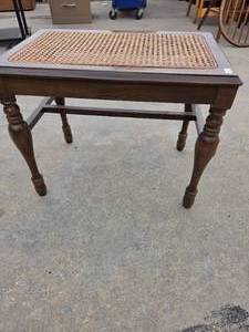 lot 25159 image: Vintage wooden accent bench featuring a woven cane top and intricately turned legs