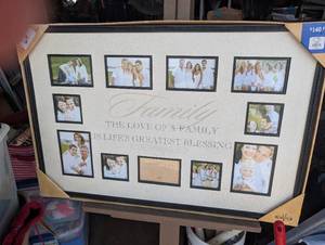 lot 69 image: Framed 11 photo collage creme mat with family-themed text