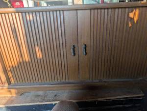 lot 136 image: Wood TV console cabinet with sliding doors