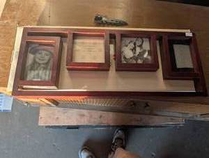 lot 142 image: Multi-opening wooden collage picture frame with a dark reddish-brown finish holding four rectangular photo slots
