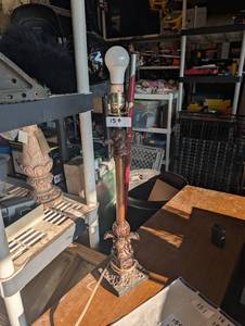 lot 154 image: Ornate vintage metalresin table lamp featuring classical decorative scrollwork and a stepped square base