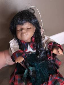 lot 803 image: Sleeping Doll with Black Hair Red Plaid Dress and Green Vest