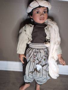 lot 809 image: Porcelain Doll with Black Hair, White Bonnet, Striped Outfit