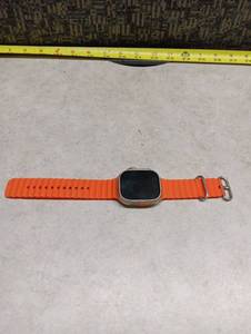 lot 216 image: Smartwatch Large Case with Orange Ocean-Style Band and Crown Button - No Visible Brand NameMark