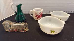 lot 1053 image: Vintage dinosaur bowls, children mug, glass train engine and small pitcher
