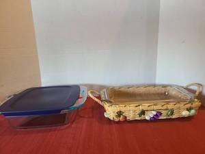 lot 1200 image: Pyrex baking dishes, 8x8 with blue lid and 10x6 in handwoven straw and raffia basket carrier