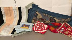 lot 1413 image: Wall hanging textiles and hot pads.