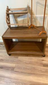 lot 2009 image: TV stand 20X29X15 on wheels with Wood Fretwork 2-Tier Shelf and Small Garment Rack located in basement